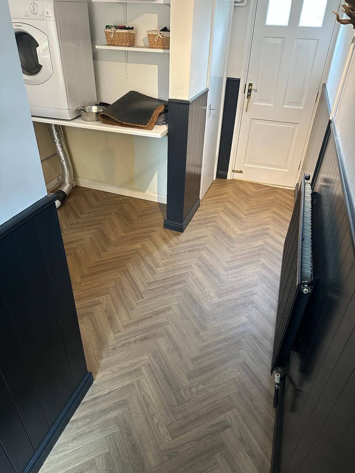 Wood-effect herringbone luxury vinyl flooring in a hallway