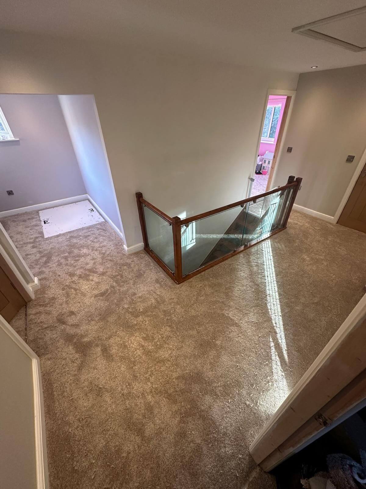 New neutral carpet fitted around a bright upstairs landing