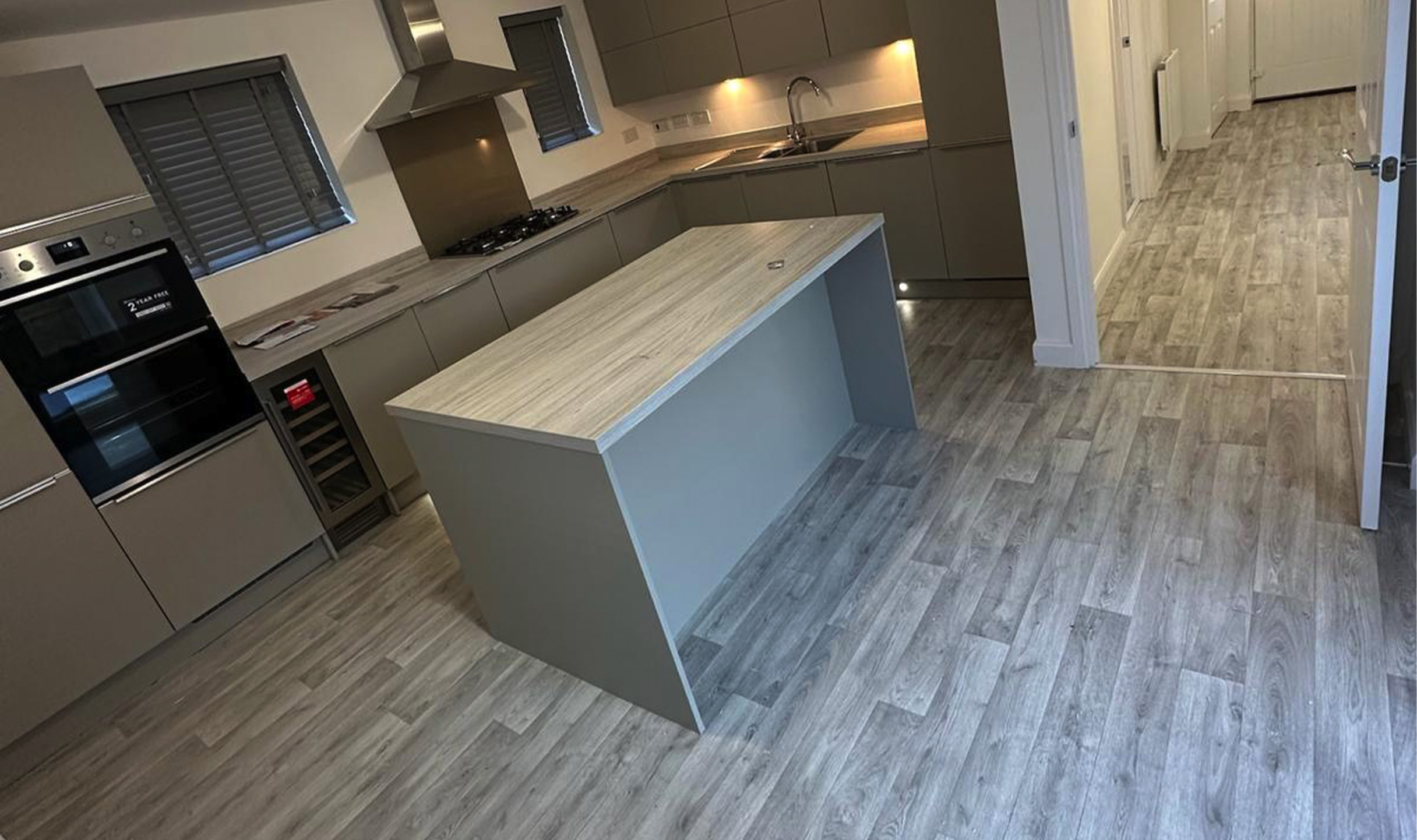 Wood-effect vinyl flooring fitted through a modern kitchen